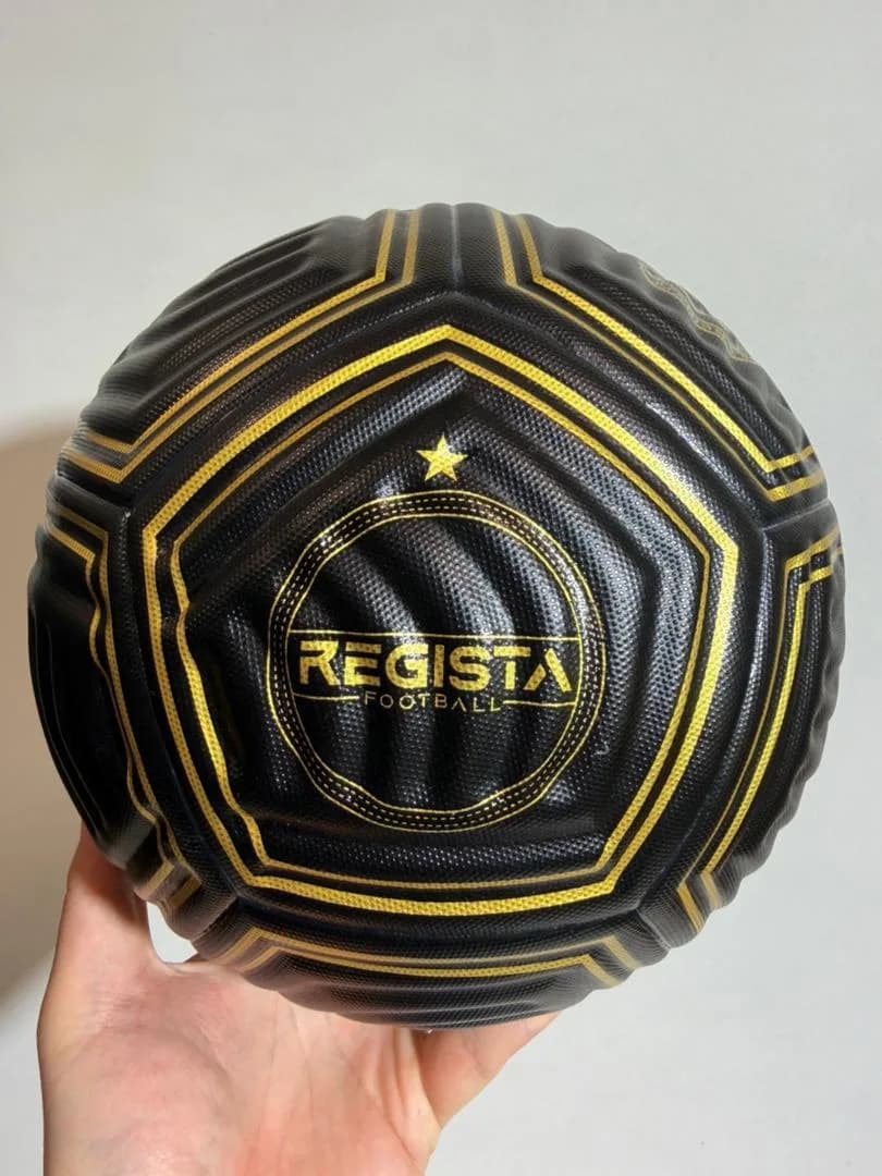 Close detail of a finished black and gold Regista football